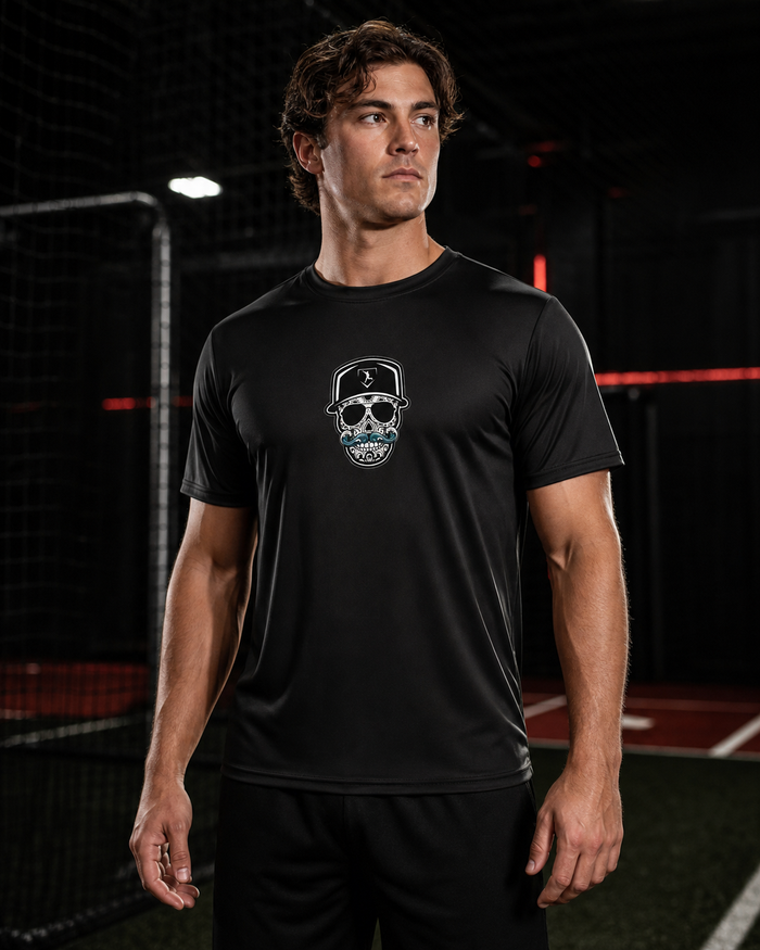 Cutternation Coastal Skull black-lens performance shirt worn by a baseball athlete in an indoor training facility