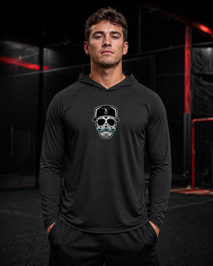 Cutternation Coastal Skull black-lens thin performance hoodie worn by a baseball athlete in an indoor training facility