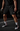 Male baseball athlete wearing black Cutternation 7-inch mesh training shorts with white Home Plate logo