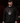 Adult baseball athlete wearing the red black and white Day of the Dead Cutternation Champion hoodie in a dark batting facility