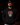 Adult baseball athlete wearing the red gold black and white Day of the Dead Cutternation Champion hoodie in a dark batting facility