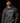 Adult baseball athlete wearing the charcoal 2024 Day of the Dead Cutternation hoodie in a dark batting facility