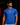 Adult baseball athlete wearing the royal blue A4 Home Plate Cutternation performance shirt in a dark batting facility