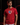 Adult baseball athlete wearing the red American Flag Cutternation performance tee in a dark batting facility