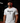 Adult baseball athlete wearing the white Bangerz Cutternation tri-blend tee in a dark batting facility
