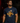 Adult baseball athlete wearing the navy Barrel Party Cutternation tri-blend tee in a dark batting facility