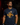 Adult baseball athlete wearing the navy Barrel Party Cutternation tri-blend tee in a dark batting facility