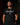 Adult baseball athlete wearing the black Been There Cutternation tri-blend tee in a dark batting facility