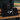 Three black Cutternation 30 x 60 training towels displayed together on a baseball dugout bench