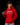 Youth baseball player wearing a red Cutternation script logo hoodie in a dark batting cage