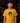 Youth baseball player wearing a golden yellow Cutternation Brown and Yellow Day of the Dead T-shirt in an indoor batting cage