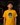 Youth baseball player wearing a golden yellow Cutternation Brown and Yellow Day of the Dead T-shirt in an indoor batting cage