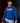 Youth pitcher wearing a royal blue Cutternation Don't Think Just Throw hoodie in a dark training facility