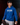 Youth pitcher wearing a royal blue Cutternation Don't Think Just Throw hoodie in a dark training facility