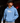 Youth baseball player wearing a Carolina blue Cutternation Ew hoodie in a dark batting cage