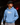 Youth baseball player wearing a Carolina blue Cutternation Ew hoodie in a dark batting cage