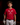 Youth hitter wearing a red Cutternation crossed-bats home plate T-shirt in an indoor batting cage