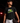 Teen baseball player wearing black Cutternation Lemon Lime Strike youth T-shirt in a dark training facility