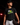 Teen baseball player wearing black Cutternation Lemon Lime Strike youth T-shirt in a dark training facility