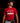 Teen baseball player wearing red Cutternation Let It Fly Factory youth T-shirt in a dark training facility
