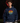 Youth hitter wearing a navy Cutternation Live at Bats sunset hoodie in an indoor batting cage