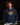Youth hitter wearing a navy Cutternation Live at Bats sunset hoodie in an indoor batting cage