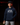 Youth pitcher wearing the navy Cutternation Live or Die By Your Best Pitch hoodie in an indoor training facility