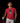 Youth baseball player wearing the Cutternation navy and red Day of the Dead T-shirt in an indoor batting cage