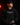 Youth pitcher wearing a black Cutternation Pitching Gangster hoodie in a dark bullpen