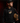 Teen baseball player wearing black Cutternation Punching Tickets youth hoodie in a dark training facility