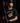 Teen baseball hitter wearing black Cutternation Punching Tickets youth T-shirt in a dark batting cage