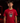 Youth baseball player wearing a red Cutternation Red and Yellow Day of the Dead T-shirt in an indoor batting cage
