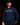 Teen baseball player wearing navy Cutternation Strength youth hoodie in a dark training facility