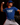 Youth pitcher wearing a blue Cutternation Strikeout Savage T-shirt in a dark training facility