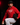 Youth pitcher wearing a red Cutternation Strikeout Season hoodie in a dark indoor bullpen