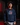 Youth baseball player wearing a navy Cutternation Vice palm graphic hoodie in an indoor batting cage