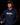 Teen baseball player wearing navy Cutternation Weird youth hoodie in a dark training facility
