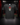 Youth Baseball T-Shirt — Jingle — Cutternation 4:5 product hero in a black and red indoor baseball training facility