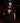 Youth baseball player wearing the Cutternation Red Santa black T-shirt in an indoor training facility