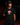 Youth baseball player wearing the Cutternation Red Santa black T-shirt in an indoor training facility